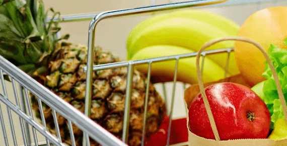 A close up of an apple, banana and pineapple